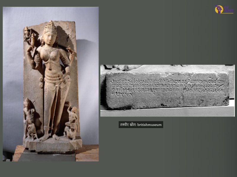 Stone statue of a standing Hindu goddess with multiple arms and intricate jewelry, flanked by small figures at the base, mounted on a pedestal.