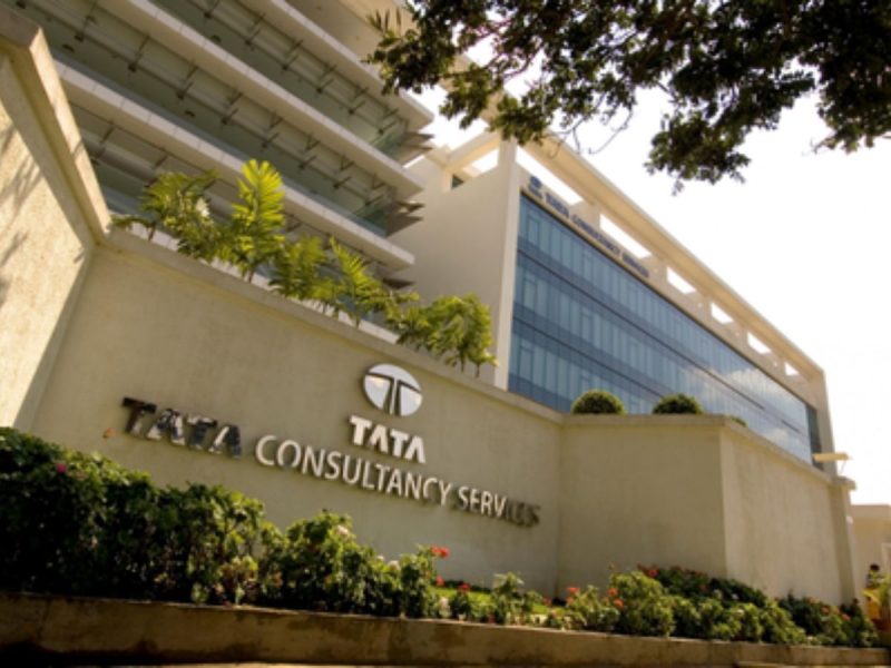 Exterior view of the Tata Consultancy Services building with a glass-fronted façade and landscaped foreground.