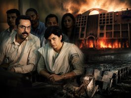 A group of somber Indian adults seated in a courtroom setting, with a blazing building visible in the background.