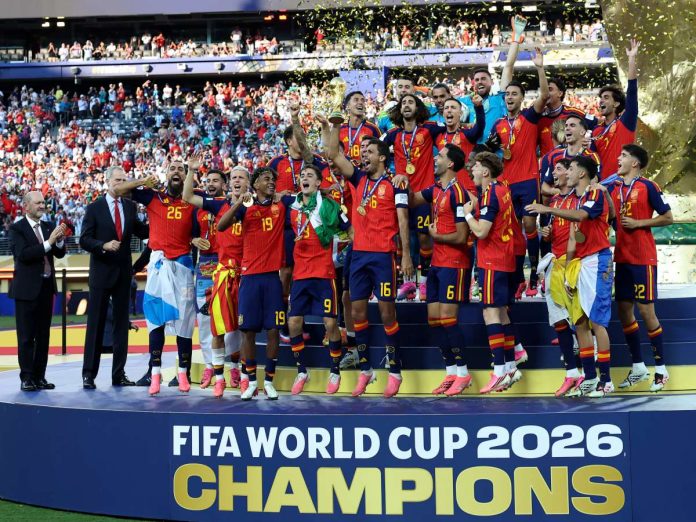 Spain national football team celebrates on the podium with trophy and medals after winning the FIFA World Cup 2026, fans in background.